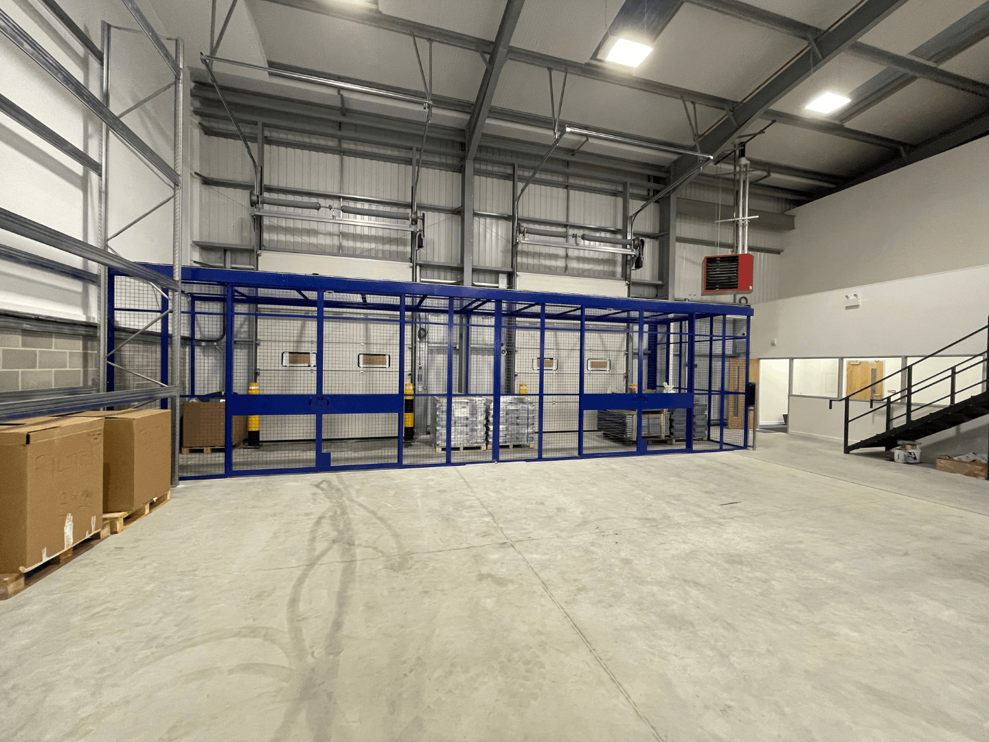 Secure blue mesh partitioning enclosure installed inside Cromwell Tools Bristol Hub warehouse