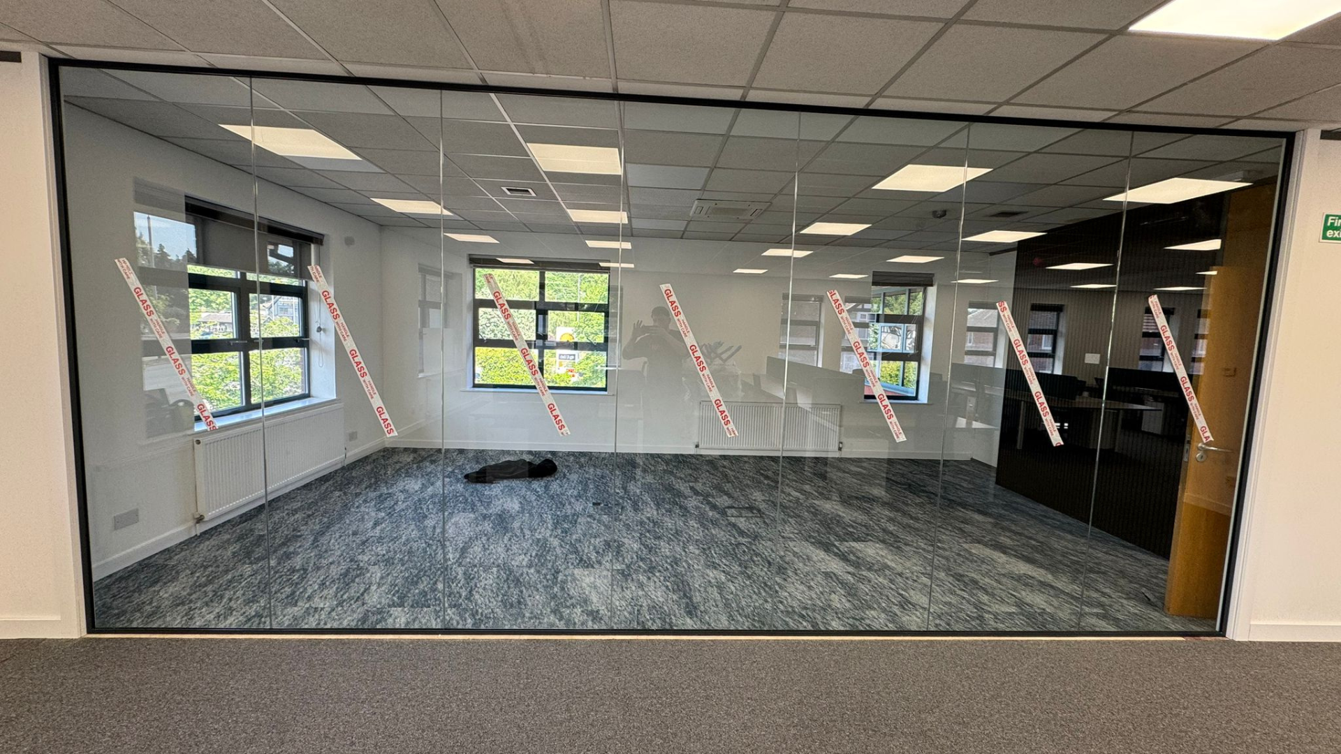 Full-height glass partitioning for the DSL Systems office fit out separating the boardroom from the surrounding office space