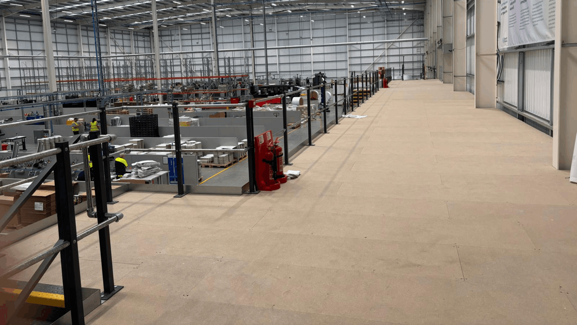 Open mezzanine floor installation at smurfit westrock with staircase access and perimeter handrails