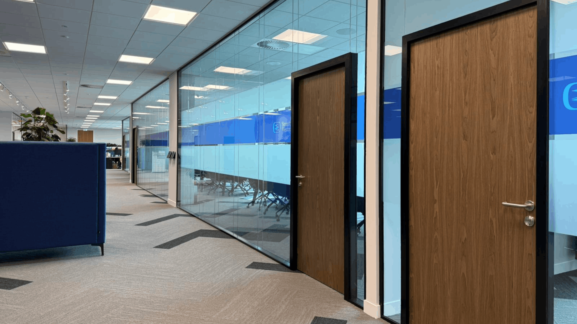 Smurfit Westrock meeting room with large tables, presentation screen, mobile whiteboard and window views